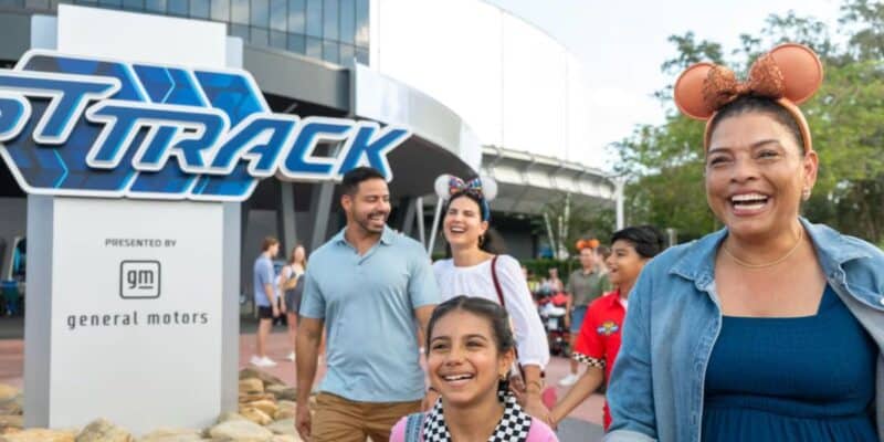a family happily exits test track in disney world's epcot park