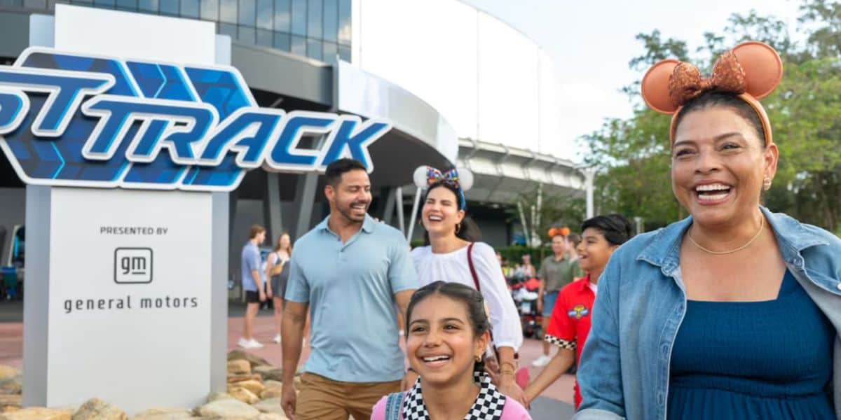 a family happily exits test track in disney world's epcot park