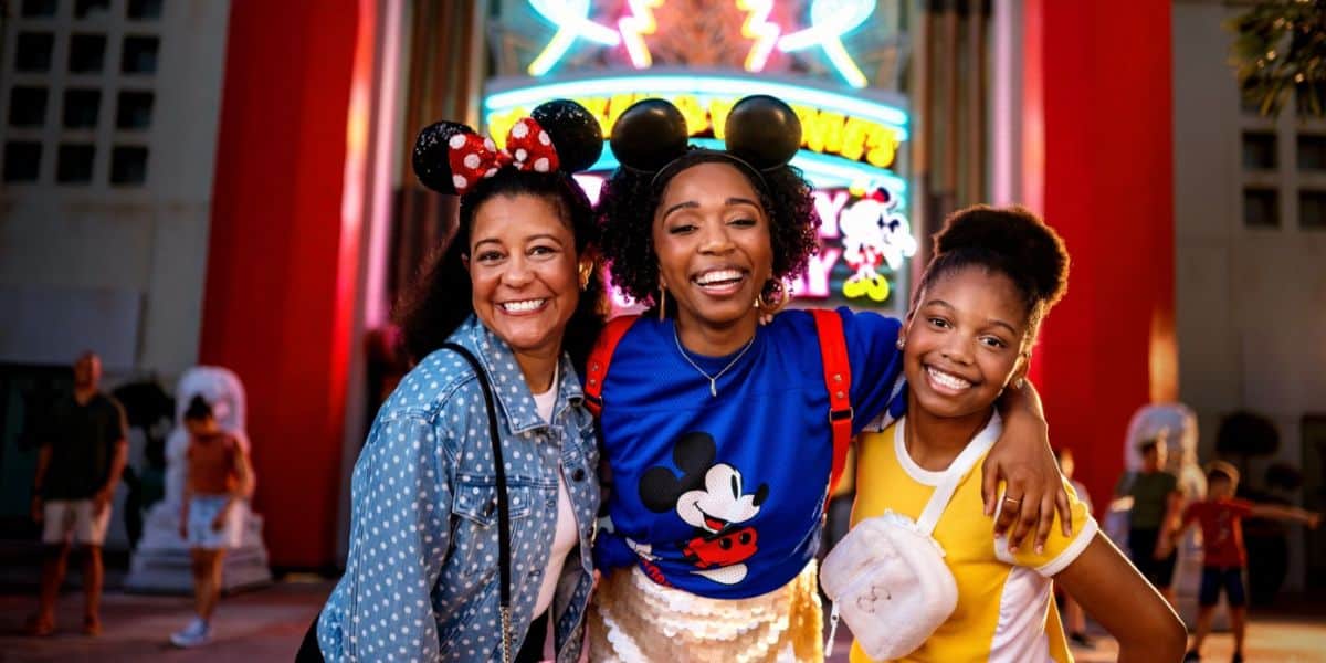 three guests in front of mickey and minnie's runaway railway ride in disney world's hollywood studios park