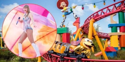 A pop star dazzles in a sparkling stage costume against the vibrant backdrop of Toy Story Land’s roller coaster and beloved Pixar character statues.