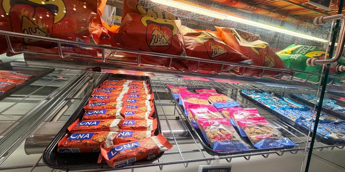 Allergy-friendly snacks and trays of Luna and Clif bars in a Disney World display case.