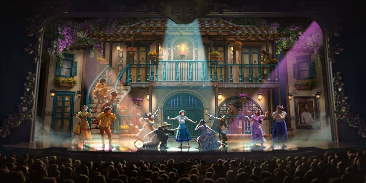 Performers on stage in an Encanto show for a theater audience.