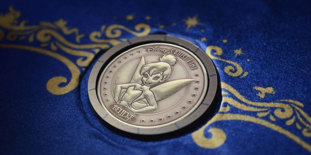 Disney Cruise Line collectible coin featuring Tinker Bell and the word “Believe.”