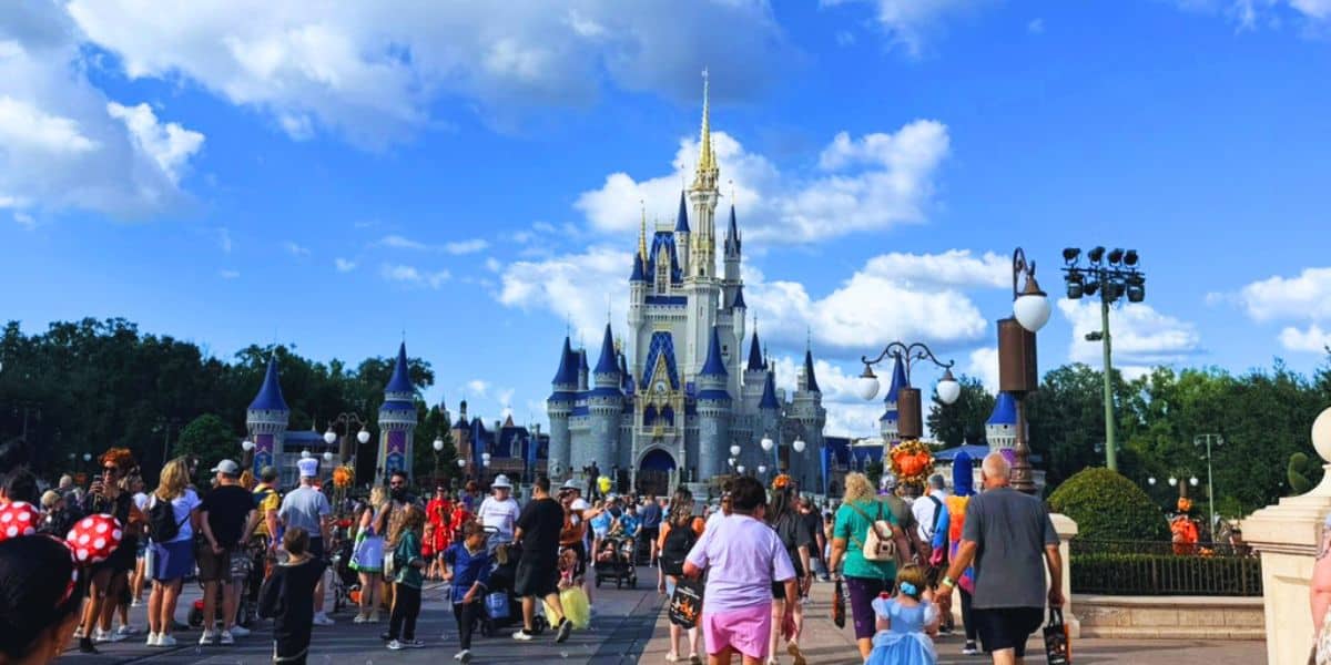 Guests walking along Main Street, U.S.A., toward Cinderella Castle at Magic Kingdom in Walt Disney World.