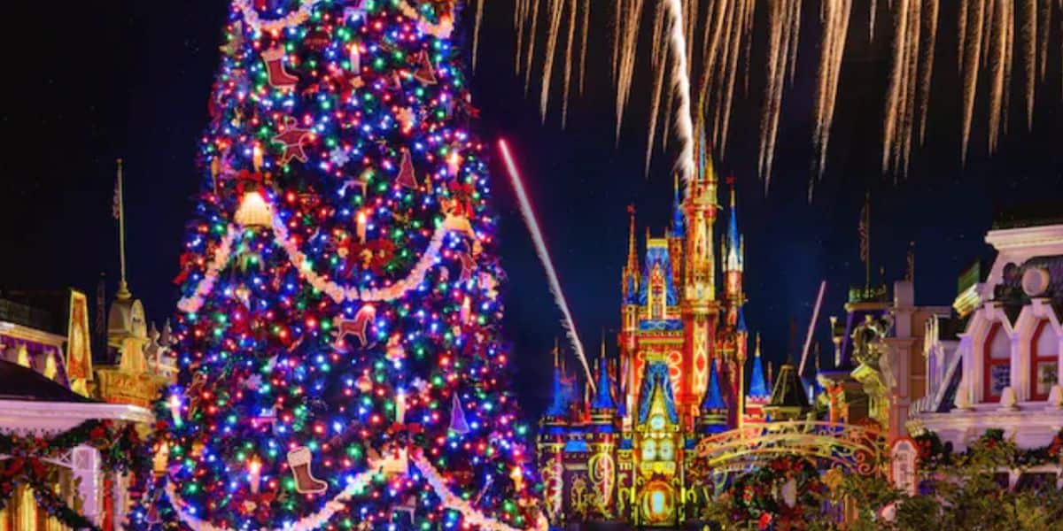 Christmas tree in front of Cinderella Castle at Magic Kingdom during holiday season.