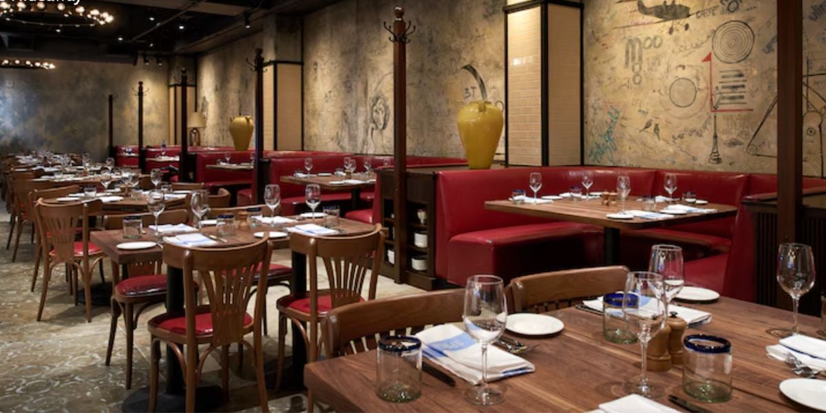 Retro-style dining area with red leather booths and wooden tables.