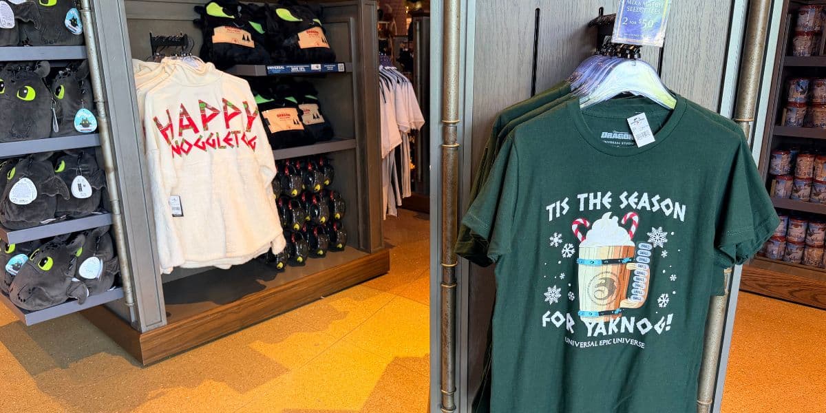 Holiday merchandise at Epic Universe, featuring a “Tis the Season for Yaknog” t-shirt and Noggle-themed gear.