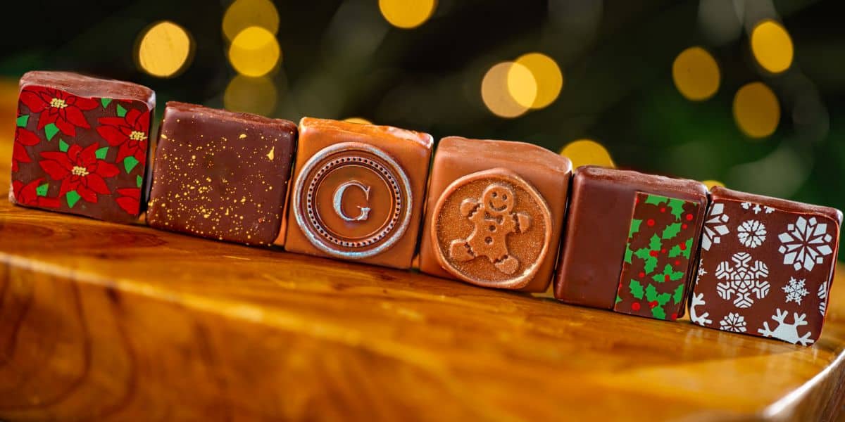 Six festive chocolate squares lined up, ready for the holiday show.