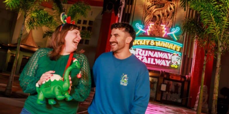 two guests at jollywood nights, one holding gertie loungefly bag and the other wearing gertie pullover shirt