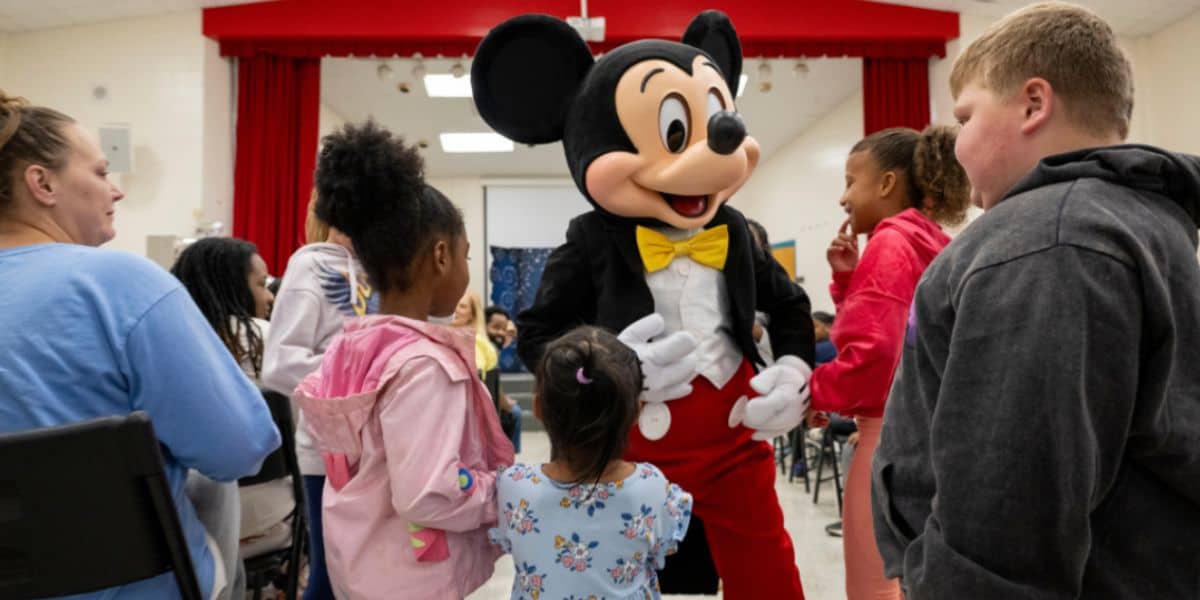 Mickey Mouse greeting children at a Disney event in North Carolina.