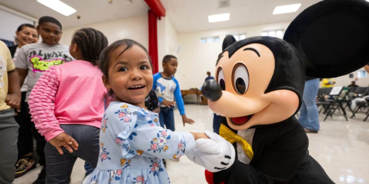 A child shaking hands with Mickey Mouse in North Carolina 