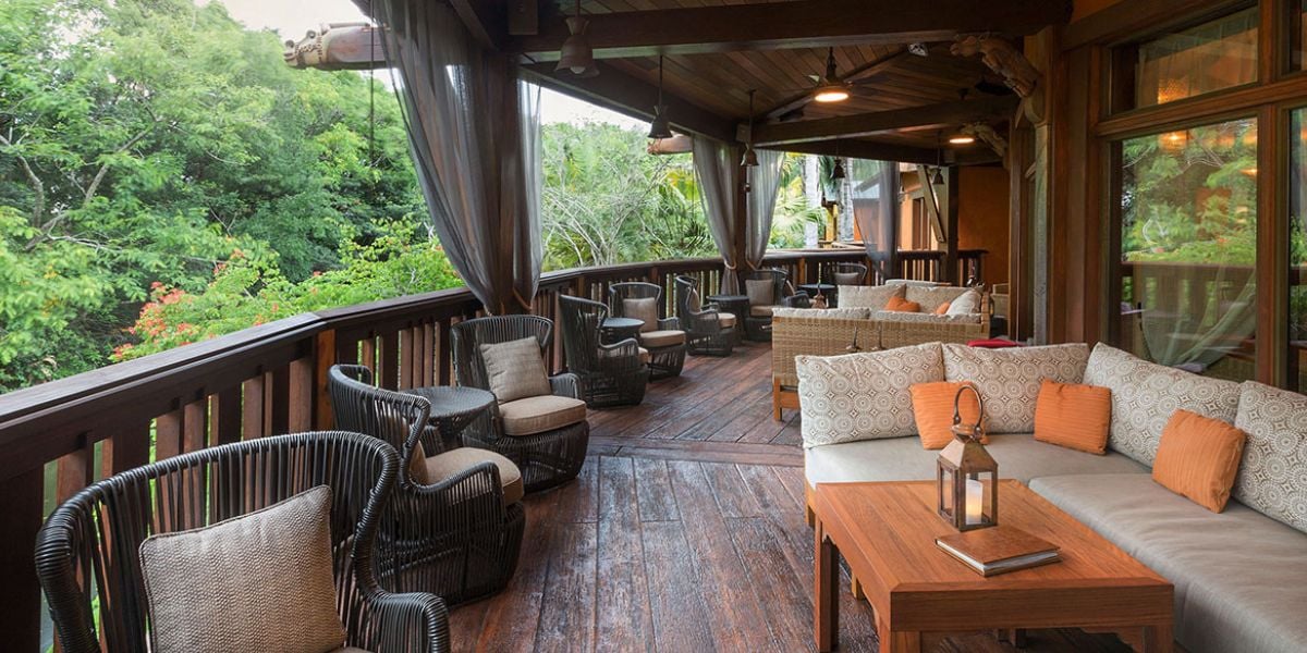 Lounge seating on a covered veranda overlooking the savanna at Disney’s Animal Kingdom Lodge.