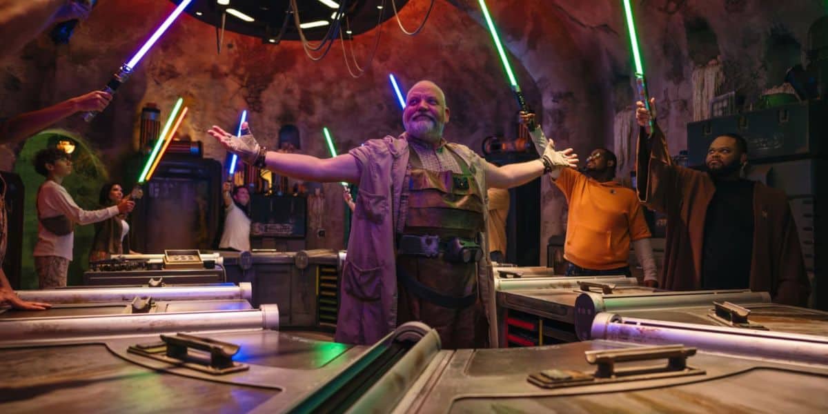 A Gatherer leads a lightsaber-building experience at Savi’s Workshop in Star Wars: Galaxy’s Edge