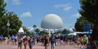 Guests walking toward Spaceship Earth at EPCOT.