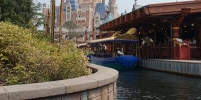 A Disney boat docked at Enchanted Storybook Castle in Shanghai Disneyland, surrounded by evacuation smoke.